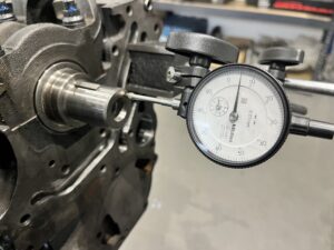 The gauge is touching the end of the crank to measure the end float of the crankshaft