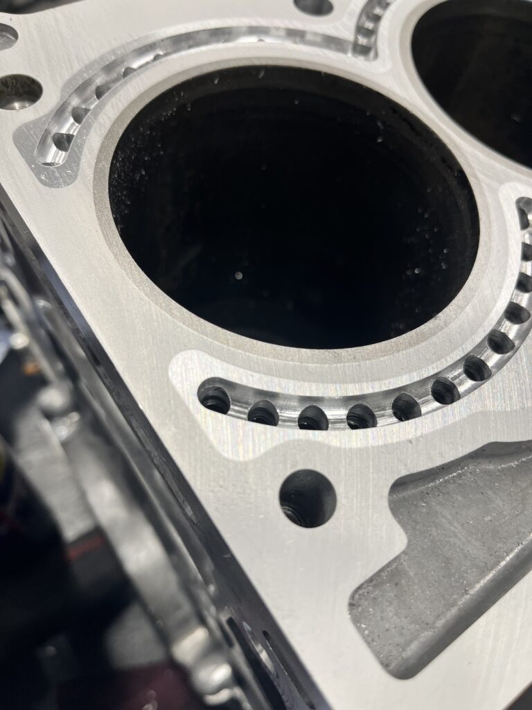 Closed deck BMW N54 block showing the insert fitted with coolant holes drilled and coolant passage valley.